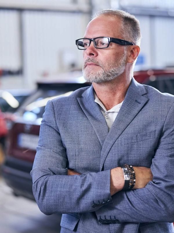 good-looking-bearded-man-standing-in-auto-repair-shop